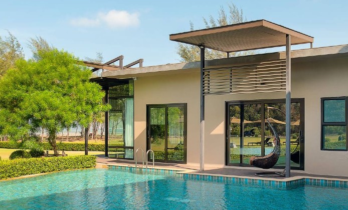 วิลล่าริมสระว่ายน้ำดีไซน์กระจกโมเดิร์นพร้อมชิงช้ารังนกแขวนที่ La Isla Pranburi Resort