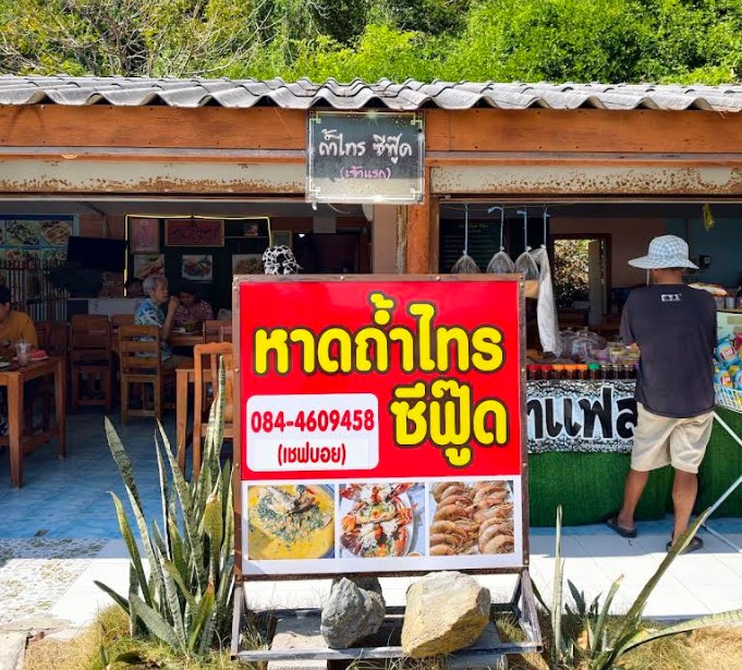 ป้ายหน้าร้านสีแดงเด่นชัดของร้าน หาดถ้ำไทรซีฟู้ด (เชฟบอย) ร้านอาหารทะเลสดๆ อร่อยเด็ดที่สามร้อยยอด
